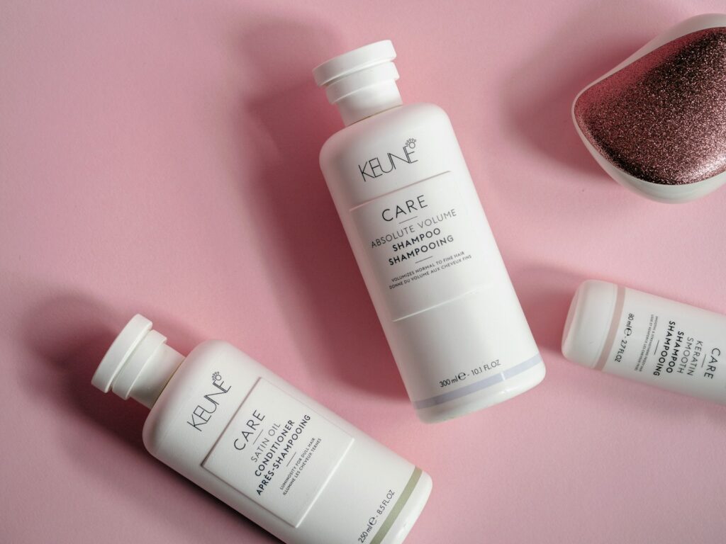 a bottle of keune care next to a container of hair care